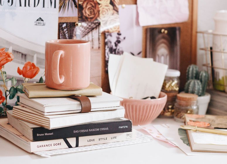 Desktop with a pretty pink cup - how to come up with blog post ideas. 