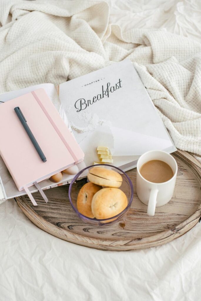 Breakfast on a platter with a notebook that says breakfast; how to keep organized as a blogger.