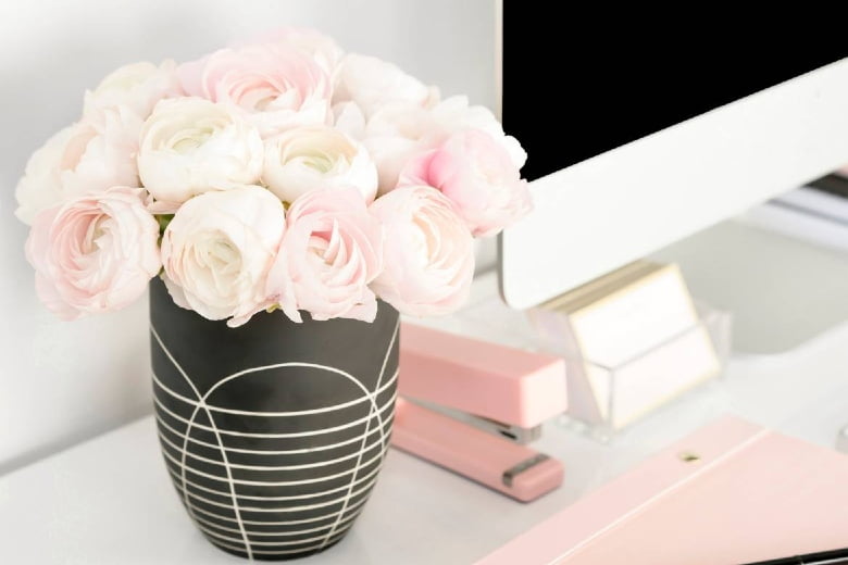 Vase of pink roses on a desktop. How to get sponsored posts for your blog