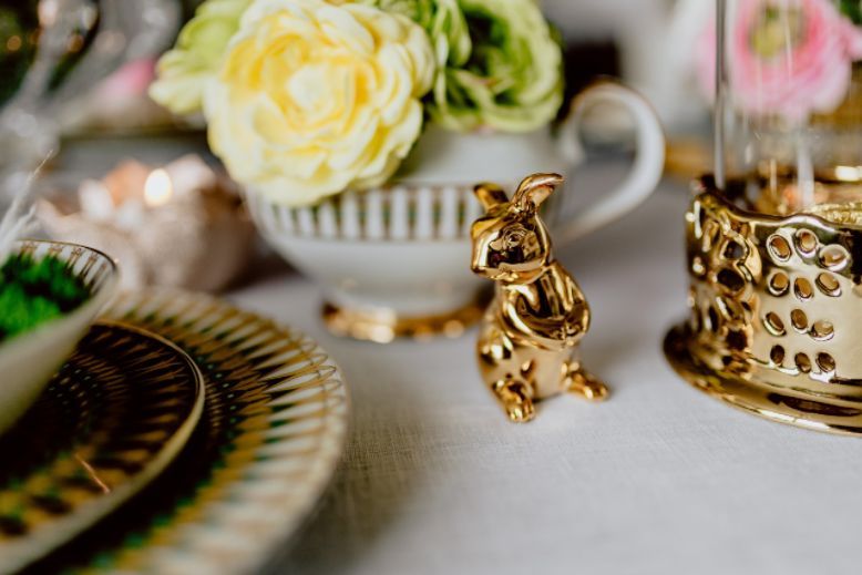 Golden bunny figurine on a dinner table - Spring iPhone wallpapers.