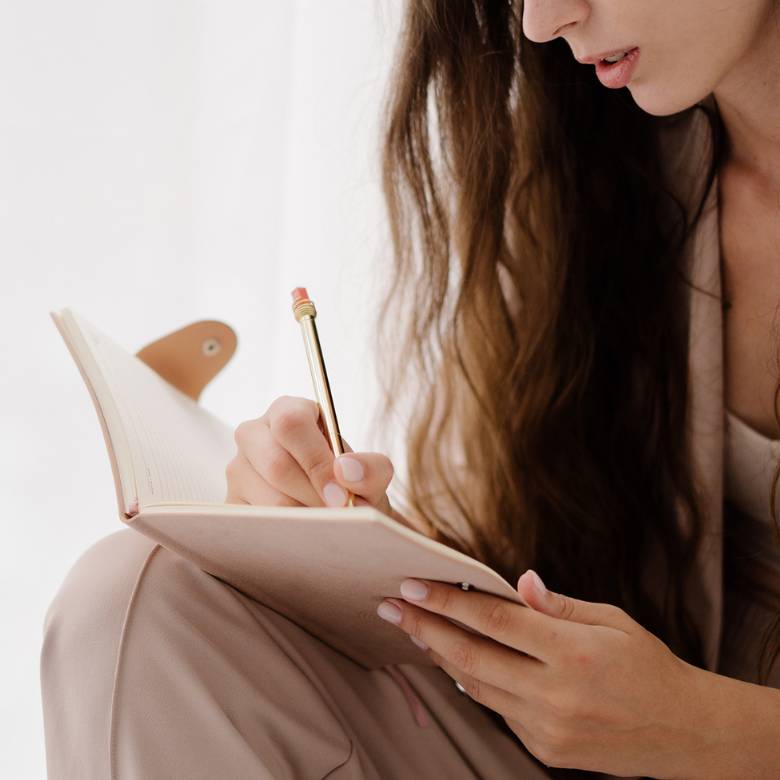 Launch It: Start A Blog Course And Toolkit 8 Woman writing in a notebook - free Launch It Start A Blog Course