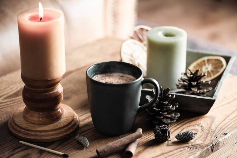 November blog post ideas - pine cones, cup of hot coffee and candles.