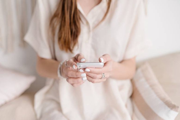 Woman using a phone - social media for bloggers.