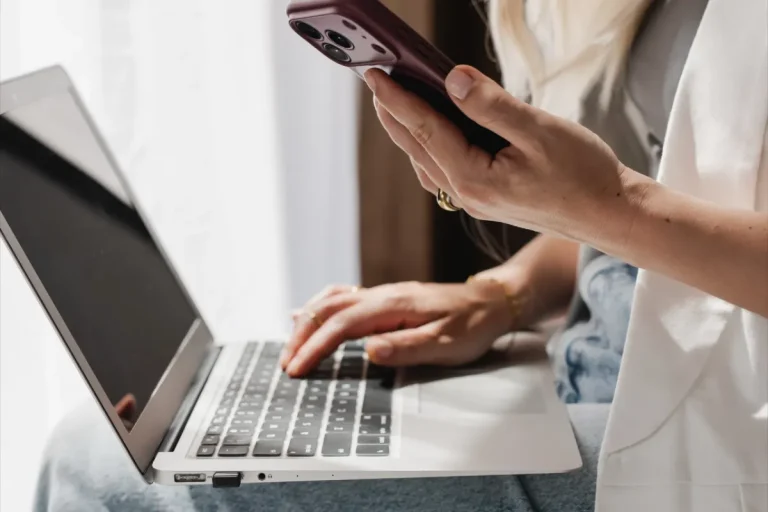 How To Make Money Blogging In 2026: A Beginner’s Guide 10 Faceless woman using a phone and laptop - how to make money blogging guide from blog coach Margaret Bourne.