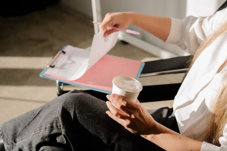 Why It's Perfectly OK To Take A Break From Blogging & How To Not Lose Momentum 1 Faceless woman sipping on coffee and writing notes - taking a blogging break with insights from blogging strategist Margaret Bourne.