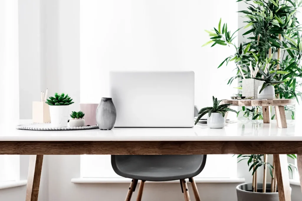 5 Work From Home Tips to Stay Focused and Get More Done 1 Laptop on a desk with a chair behind it - work from home tips from Margaret Bourne.