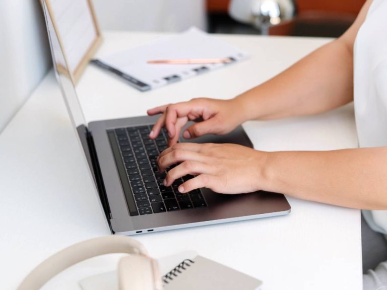 20+ Free Ways To Promote Your Blog & Drive Traffic 14 Faceless woman using laptop - how to promote your blog for free with insights from Margaret Bourne.