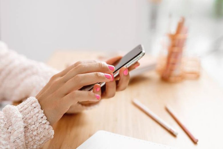 Woman's hands typing on a phone - digital marketing quotes.