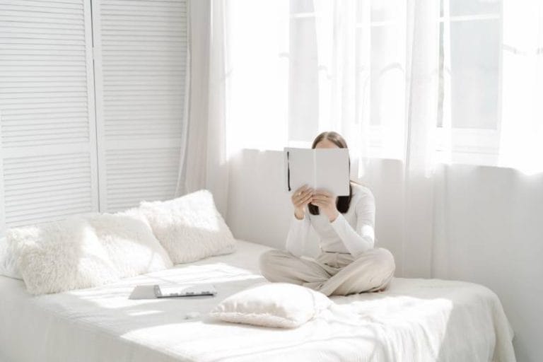 These 15 Blogging Skills Helped Me Become A Better Blogger 10 Faceless woman reading a book - blogging skills.