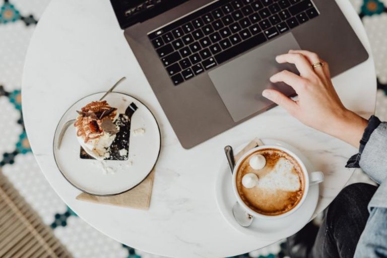 Faceless person using a laptop -how to make your blog look professional.