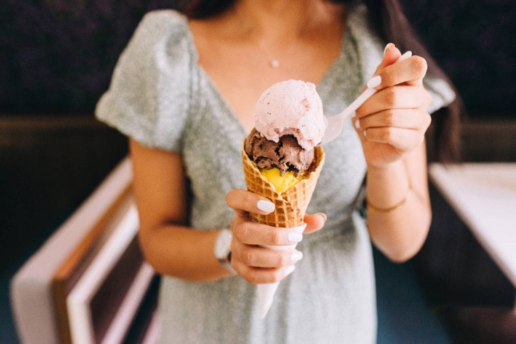 31 August Blog Post Ideas For Lifestyle Blogs To Inspire Your Readers 1 Faceless woman with ice cream cone - August blog post ideas.