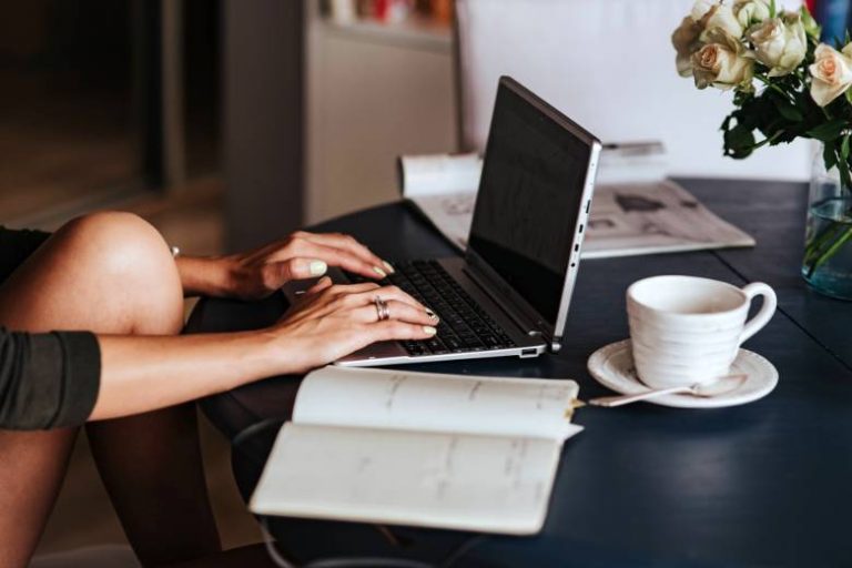 Faceless woman using a laptop - biggest SEO mistakes beginner bloggers make.