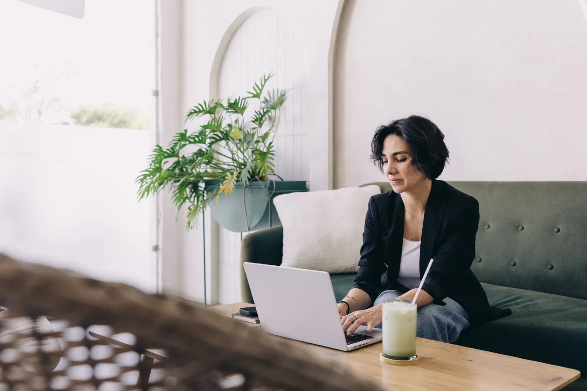 Woman using a laptop - blog menu design best practices.