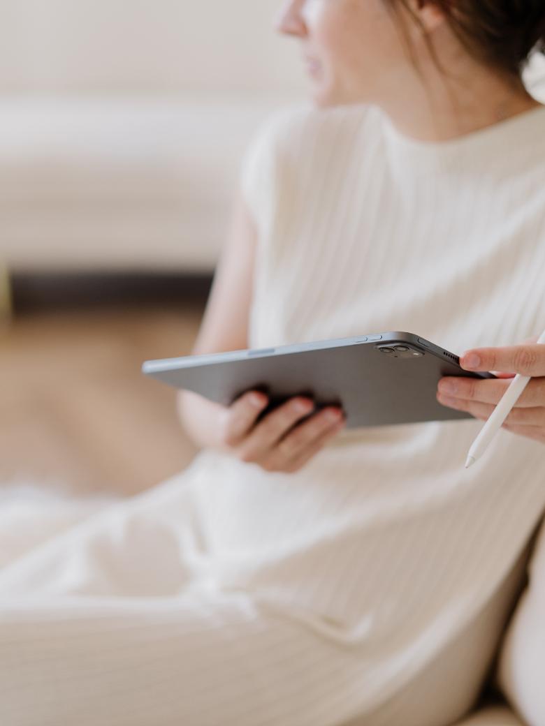 Blog Audits 4 Woman holding tablet - blog audit next steps with Margaret Bourne.